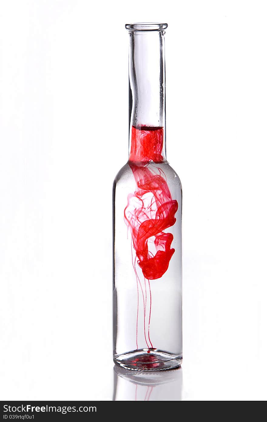 Red poison drink in bottle on white background