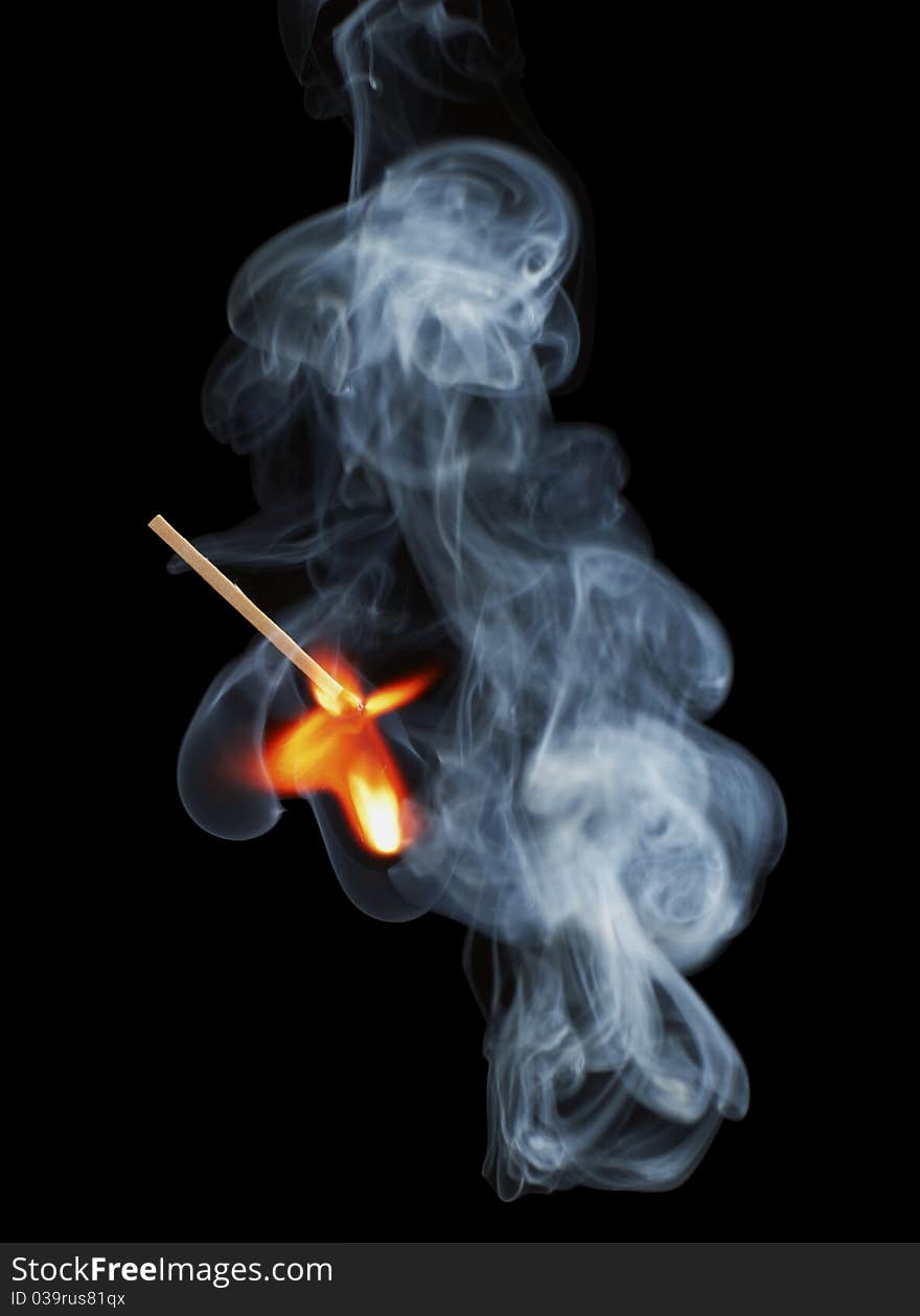 Burning match with the smoke. Isolated on black background. Burning match with the smoke. Isolated on black background