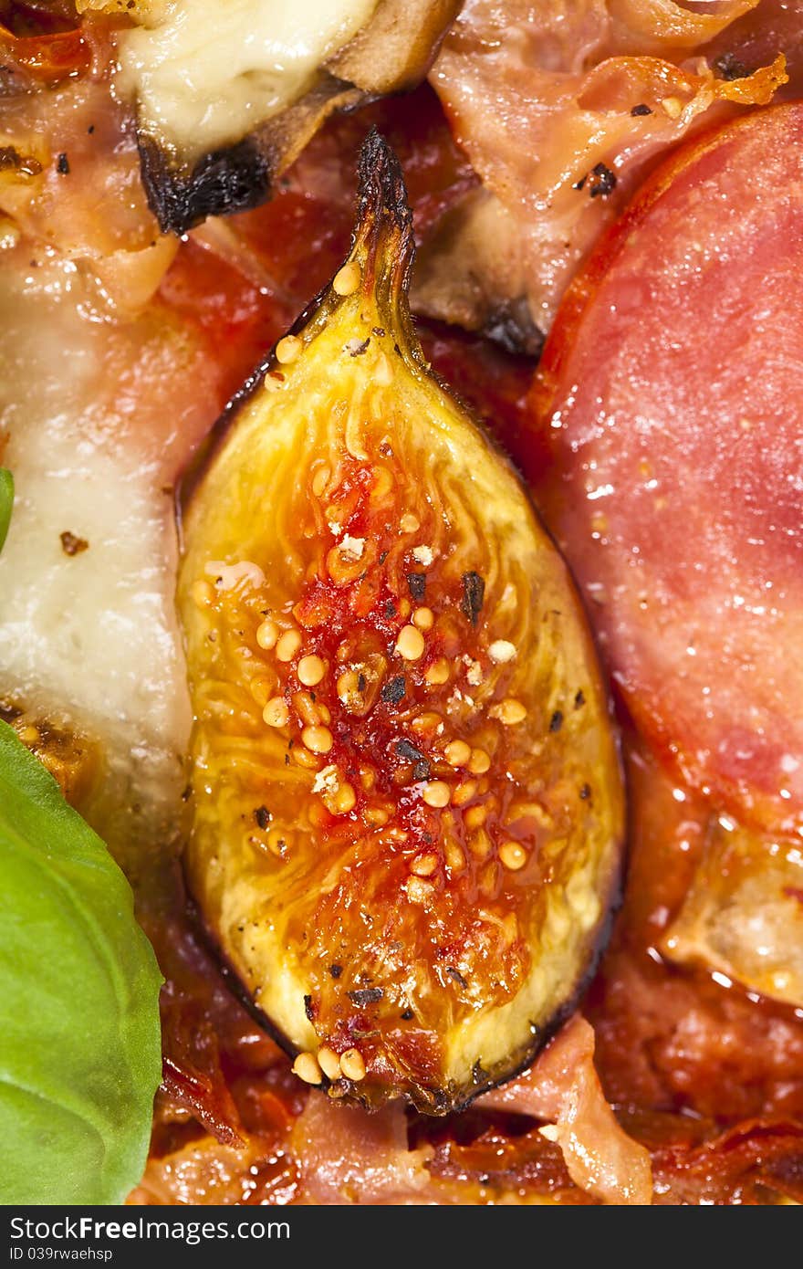 Delicious fig, mozzarella and ham pizza, closeup details