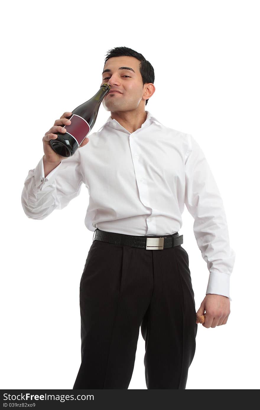 An enebriated man staggers and drinks swigging wine directly from a bottle. An enebriated man staggers and drinks swigging wine directly from a bottle.