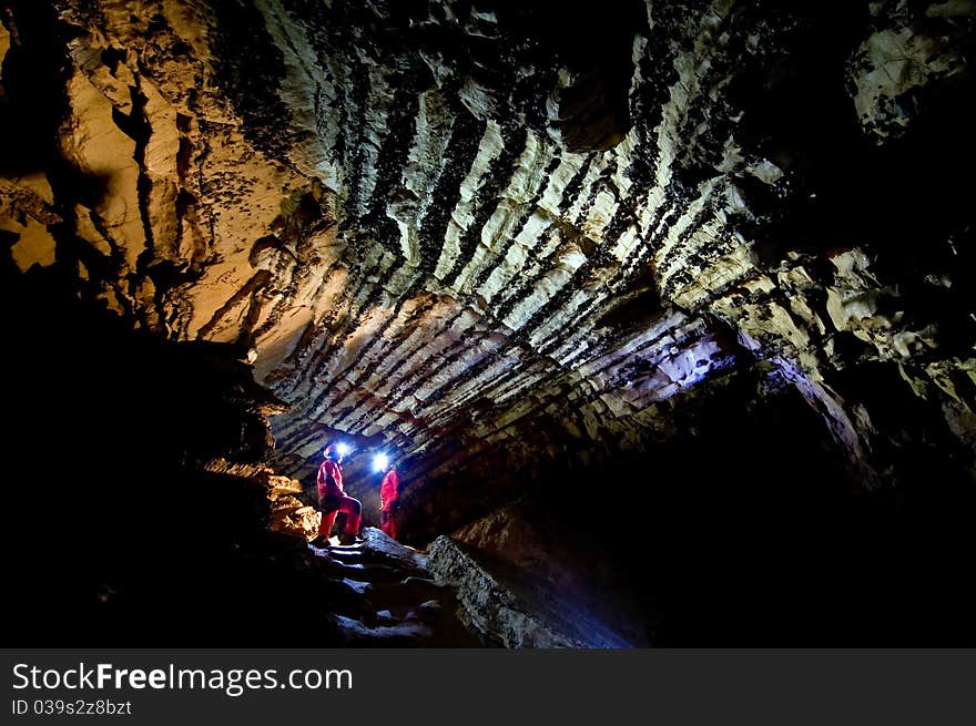 Speleologists exploring the Comarnic cave. Banatului Mountains, Romania