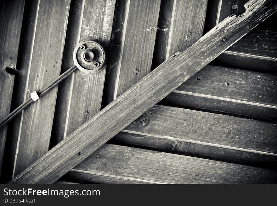 Part of the old wood door with the old electronic bell in black and white. Part of the old wood door with the old electronic bell in black and white