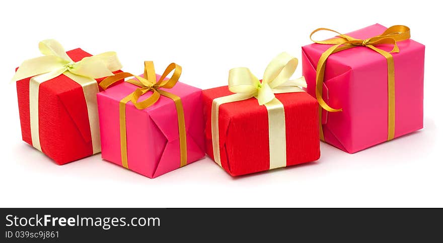 Red and pink gift boxes with satin ribbons isolated