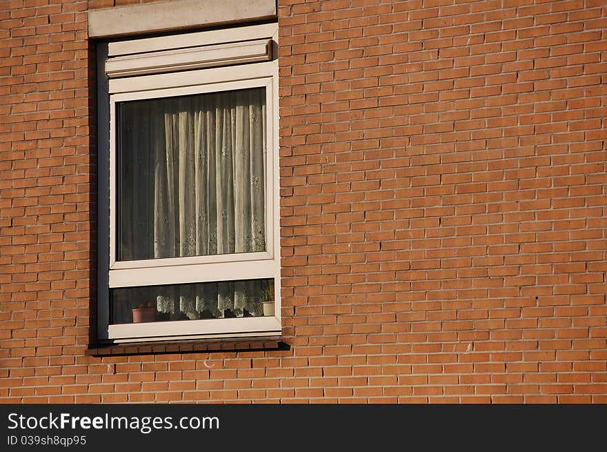 A window with a brick wall