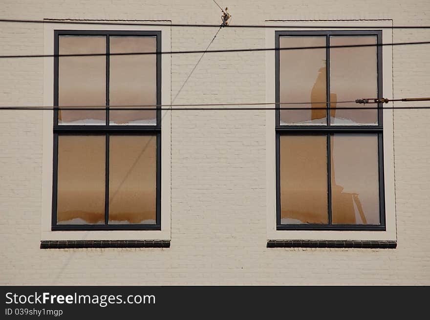 Two white windows with some cables