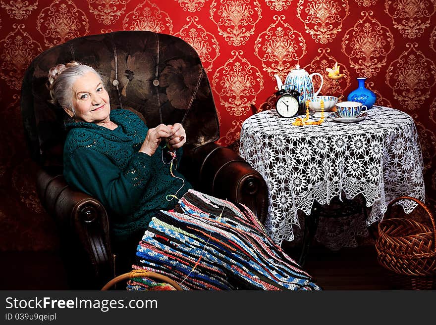 Portrait of a smiling senior woman having a rest at home. Portrait of a smiling senior woman having a rest at home.