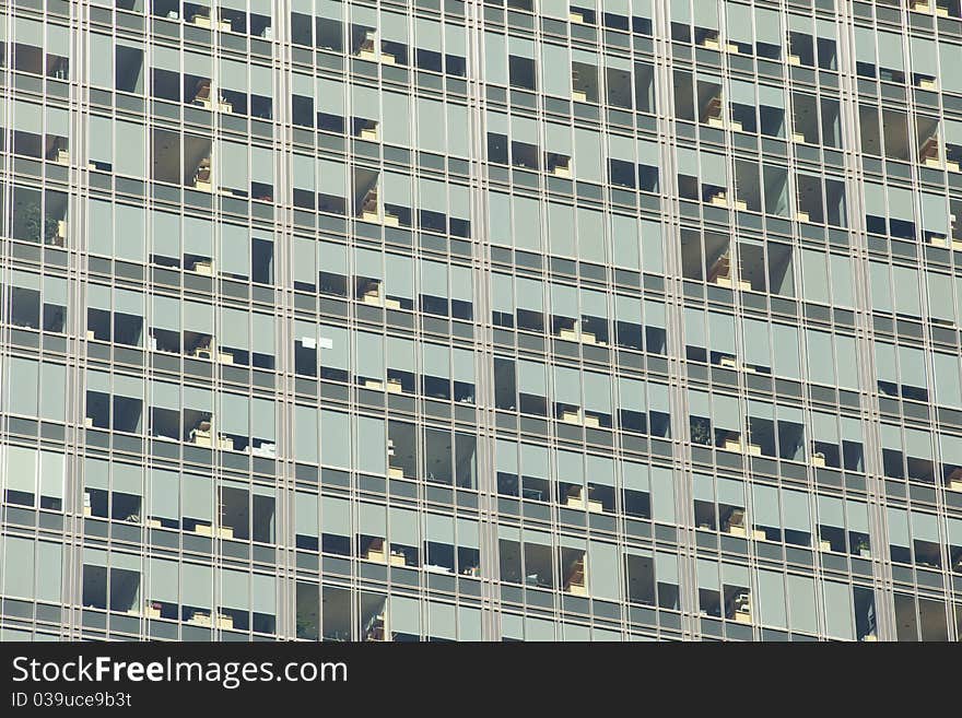 Looking up at a detail of a modern steel and glass office building. Window shades and furniture create an interesting pattern. Looking up at a detail of a modern steel and glass office building. Window shades and furniture create an interesting pattern.