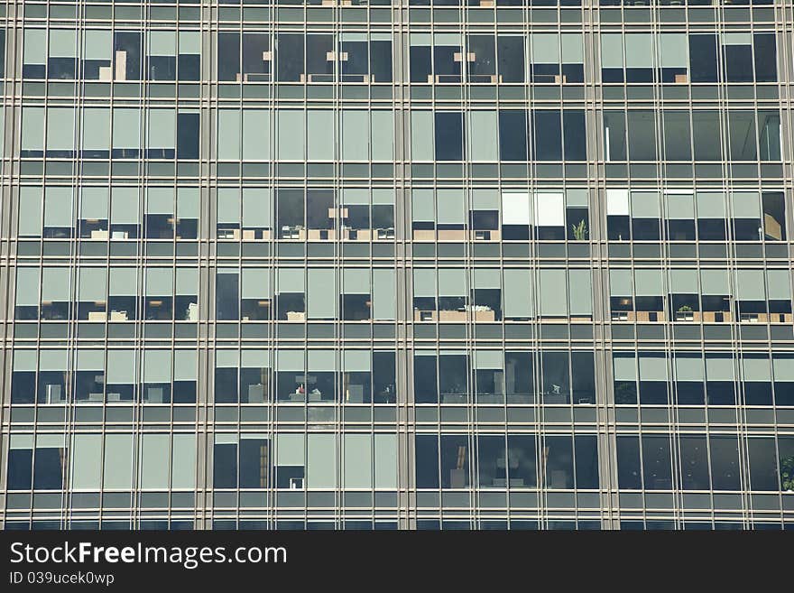 Looking up at a detail of a modern steel and glass office building. Window shades and furniture create an interesting pattern. Looking up at a detail of a modern steel and glass office building. Window shades and furniture create an interesting pattern.