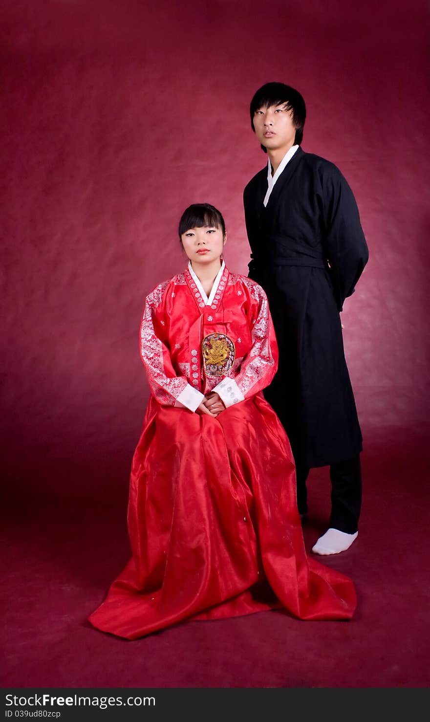 Asian traditional couple on the red background.