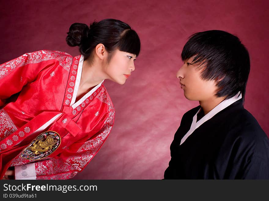 Asian traditional couple on the red background.