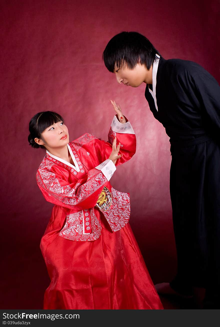 Asian traditional couple on the red background.