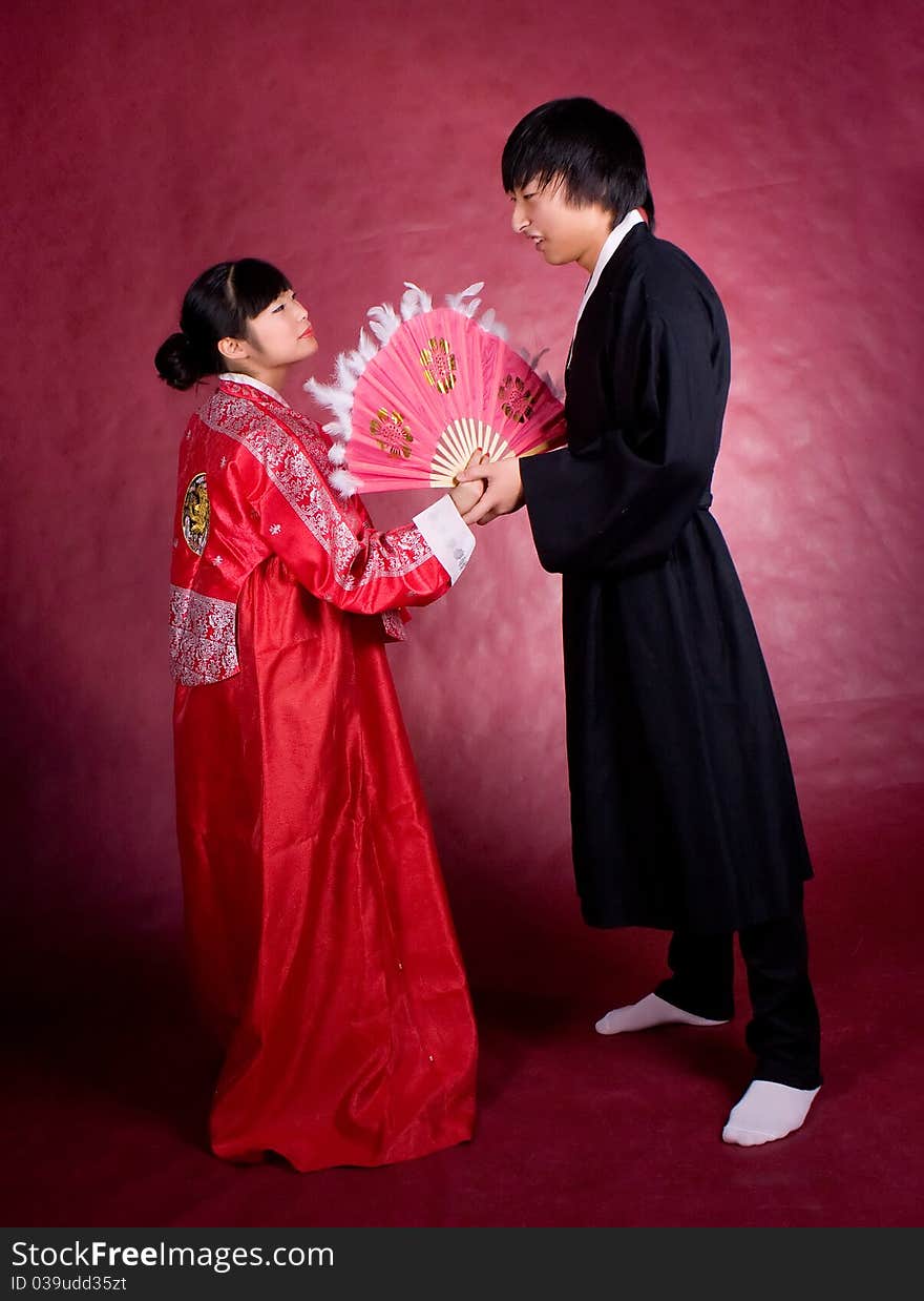 Asian traditional couple on the red background.