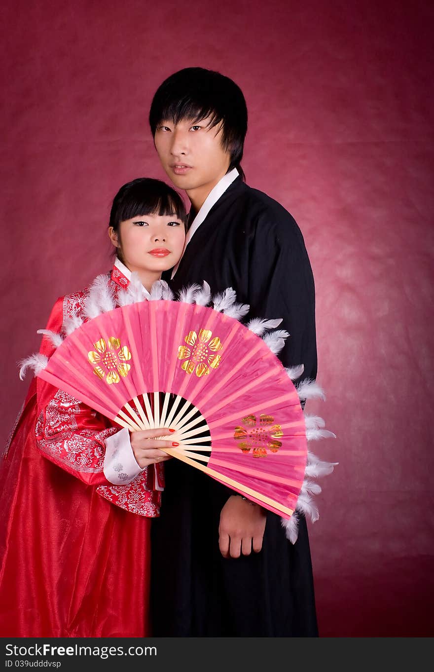 Asian traditional couple on the red background.