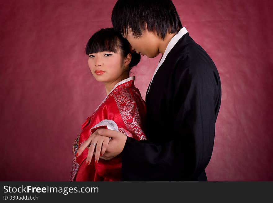 Asian traditional couple on the red background.