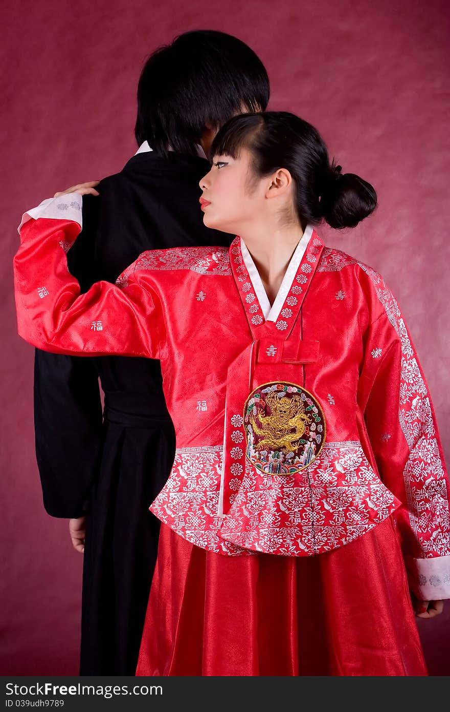 Asian traditional couple on the red background.