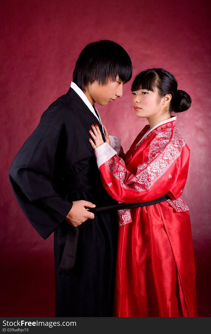 Asian traditional couple on the red background.