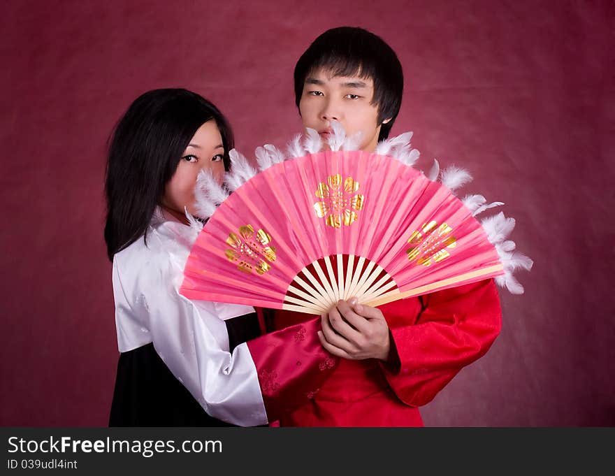 Asian traditional couple on the red background.