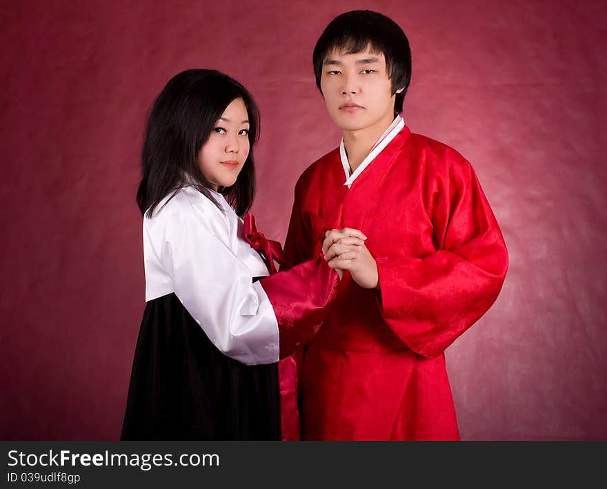 Asian traditional couple on the red background.