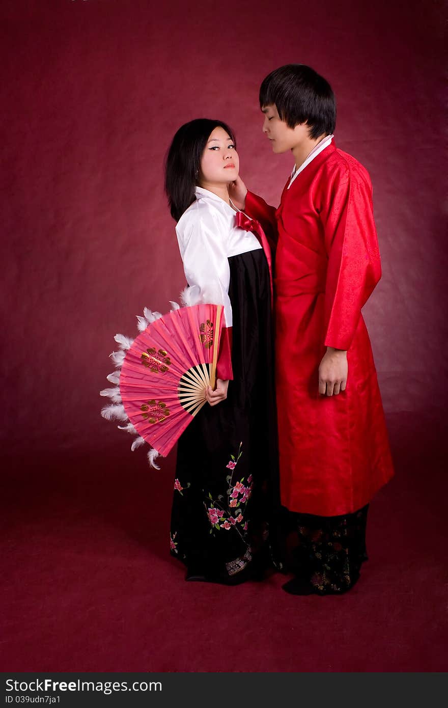 Asian traditional couple on the red background.