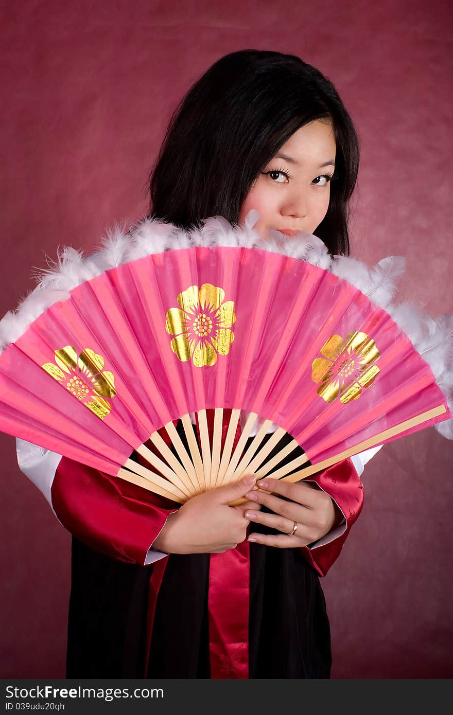 Asian woman in traditional dress with the fan