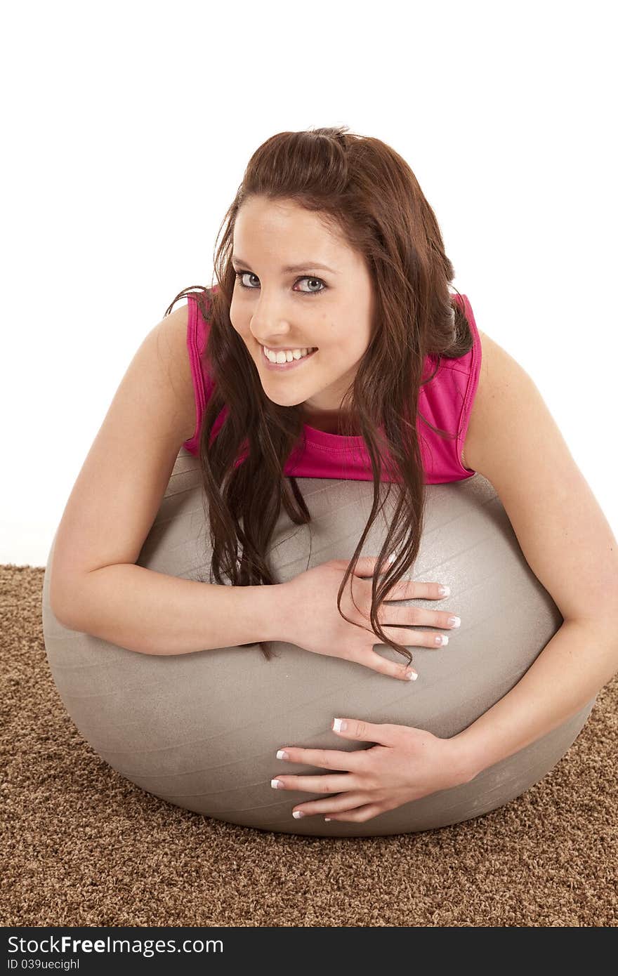 A woman is leaning on a large fitness ball. A woman is leaning on a large fitness ball.