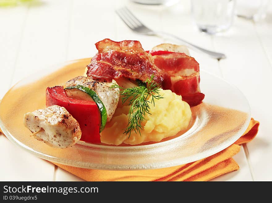 Chicken shish kebab with mashed potato and rasher of bacon. Chicken shish kebab with mashed potato and rasher of bacon