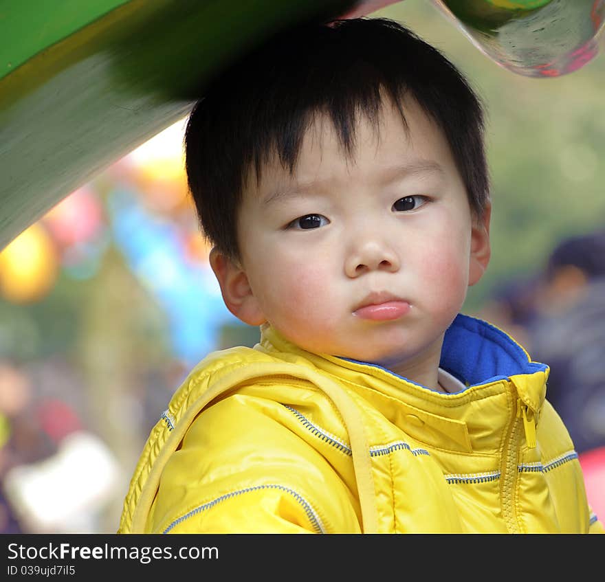 A cute baby is playing in a park