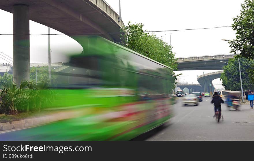 High-speed vehicles blurred trails on urban roads under overpass