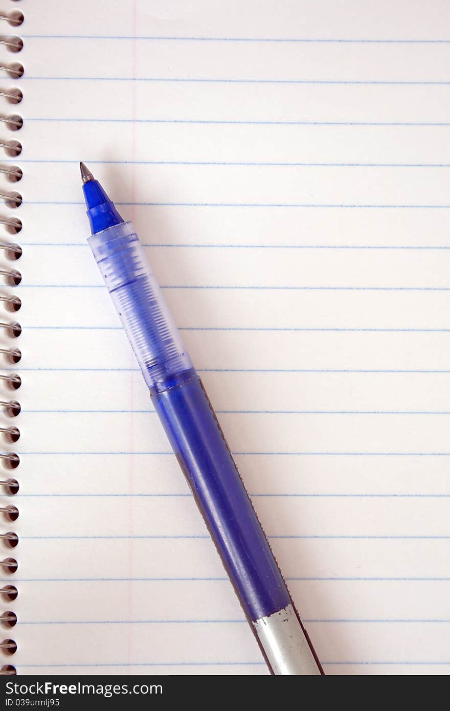 Spiral notepad and blue pen. Spiral notepad and blue pen