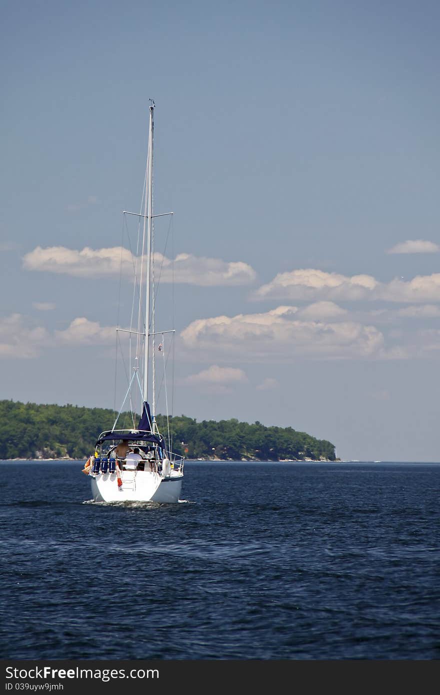 View of a sailboat off the western New York shore of Lake Champlain with the Adirondack Mountains in the background. Lake Champlain is a popular recreational spot for boaters, nestled between Vermont and New York, with Canada to the north. View of a sailboat off the western New York shore of Lake Champlain with the Adirondack Mountains in the background. Lake Champlain is a popular recreational spot for boaters, nestled between Vermont and New York, with Canada to the north.