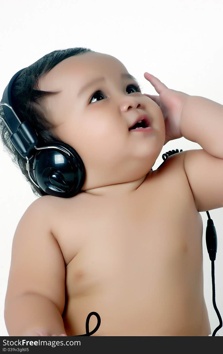 a chubby little girl listen to music with headphones isolated on white background