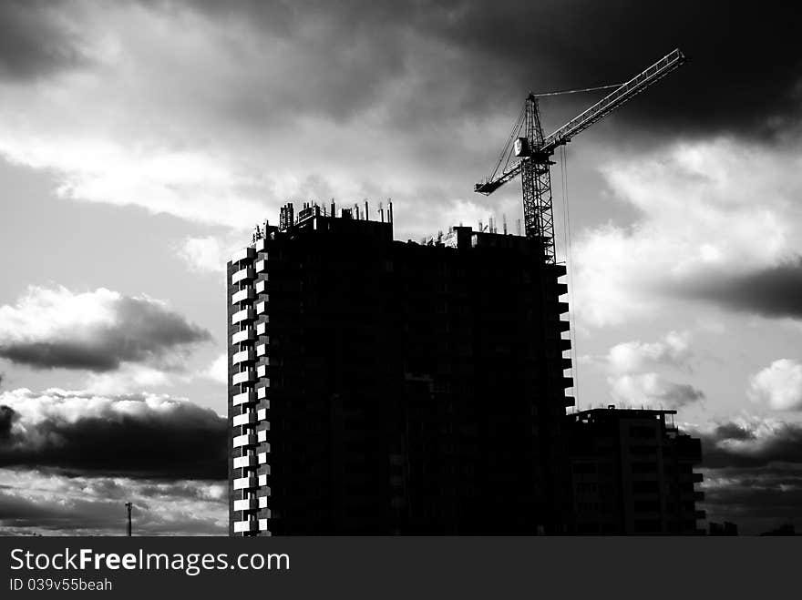 Frontal view house under construction and crane