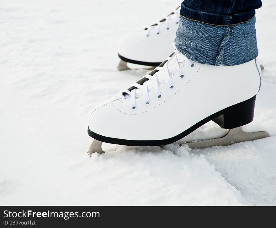 Woman Legs In White Ice Skates