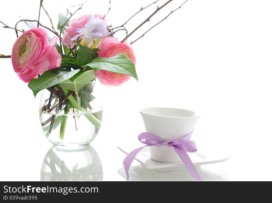 Bouquet of ranunculus with a white cup tied with a ribbon. Bouquet of ranunculus with a white cup tied with a ribbon