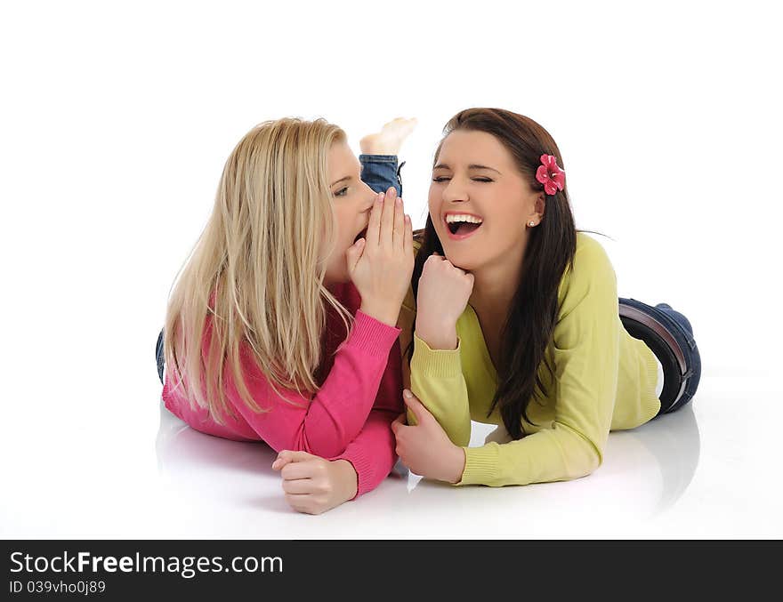 Two pretty female friends having fun and laughing. isolated on white background