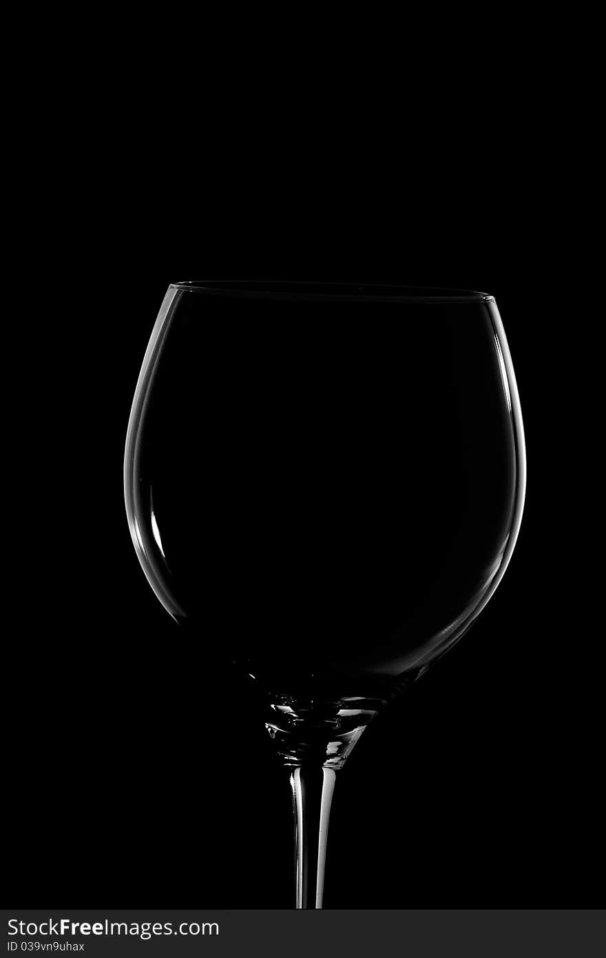 A wine glass on black background