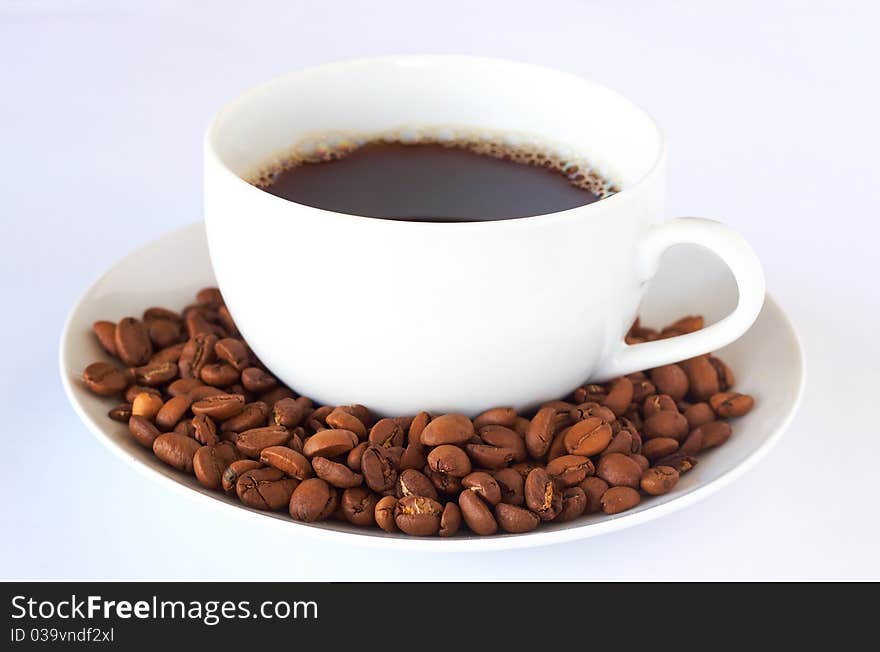 Cup filled with freshly brewed coffee and roasted coffee beans. Cup filled with freshly brewed coffee and roasted coffee beans