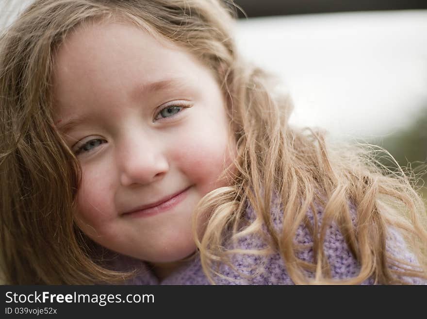 Cute little girl peeking at camera from jungle gym. Cute little girl peeking at camera from jungle gym.