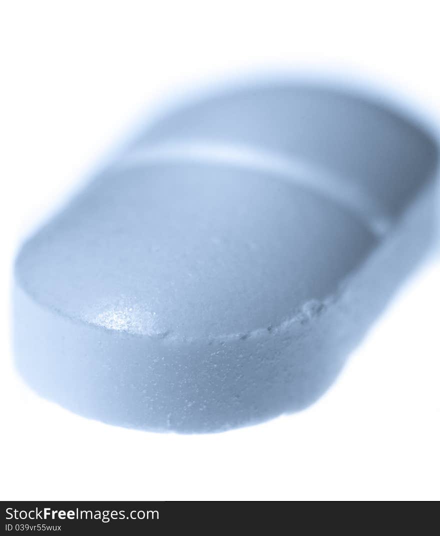 Macro of pill with blue toning