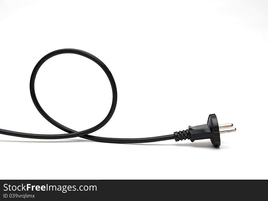 Black cable is twisted into a helix on a white background.