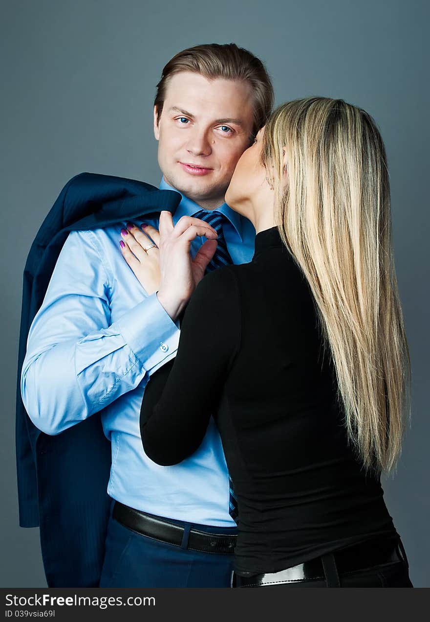 Beautiful modern young couple on the gray background