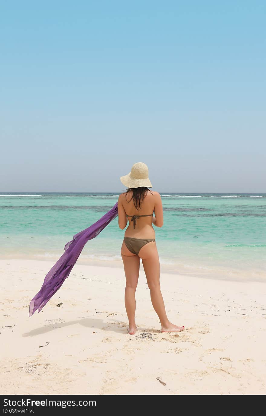 Woman with a sarong looking the sea