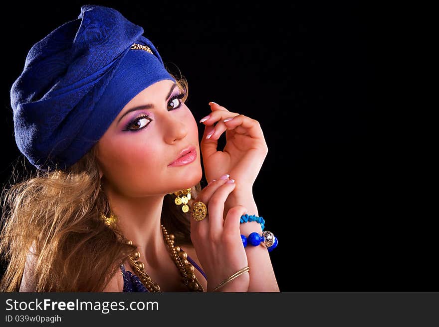 Beautiful girl in a turban and a stylized ethnic costume