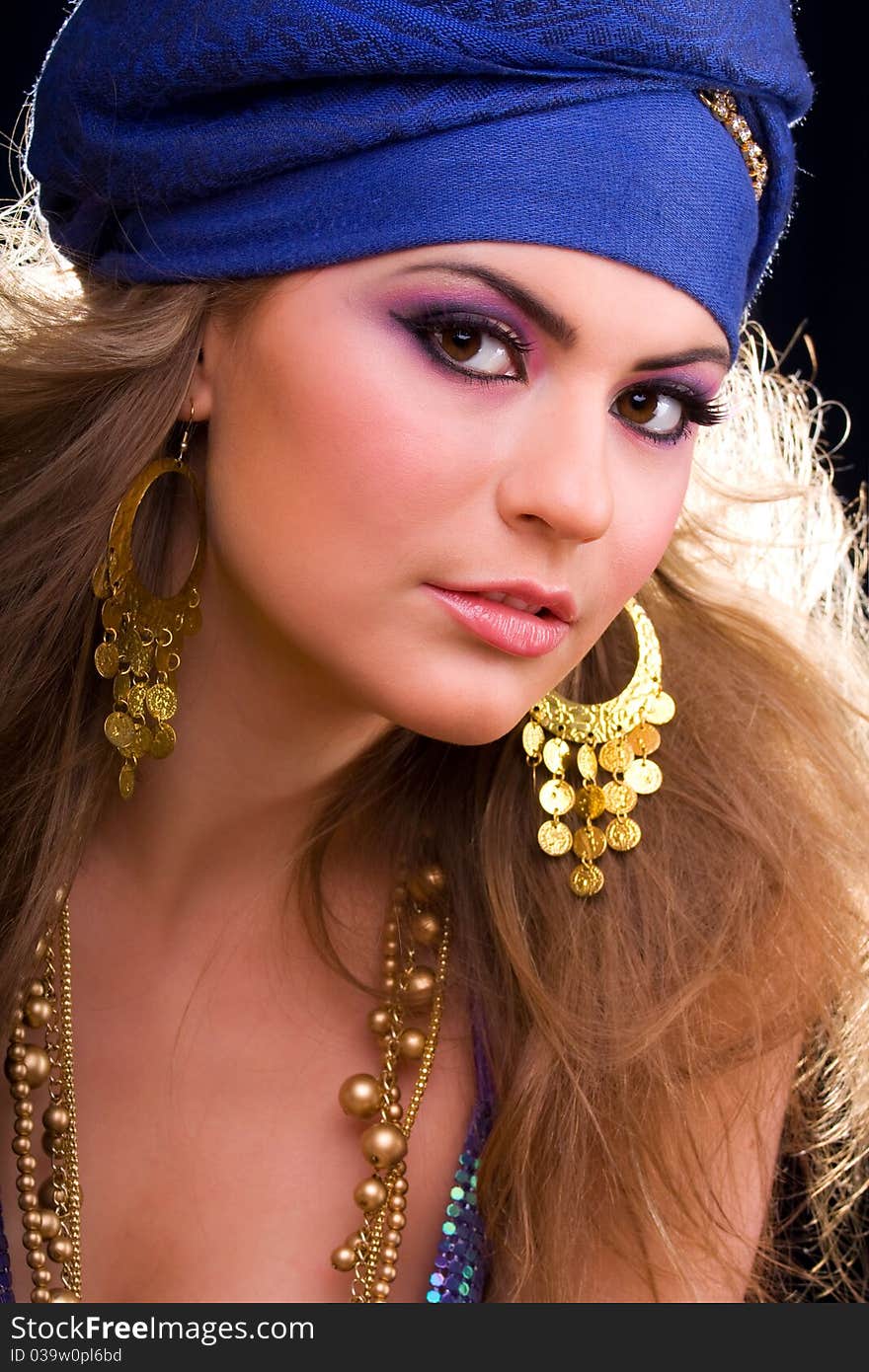 Beautiful girl in a turban and a stylized ethnic costume