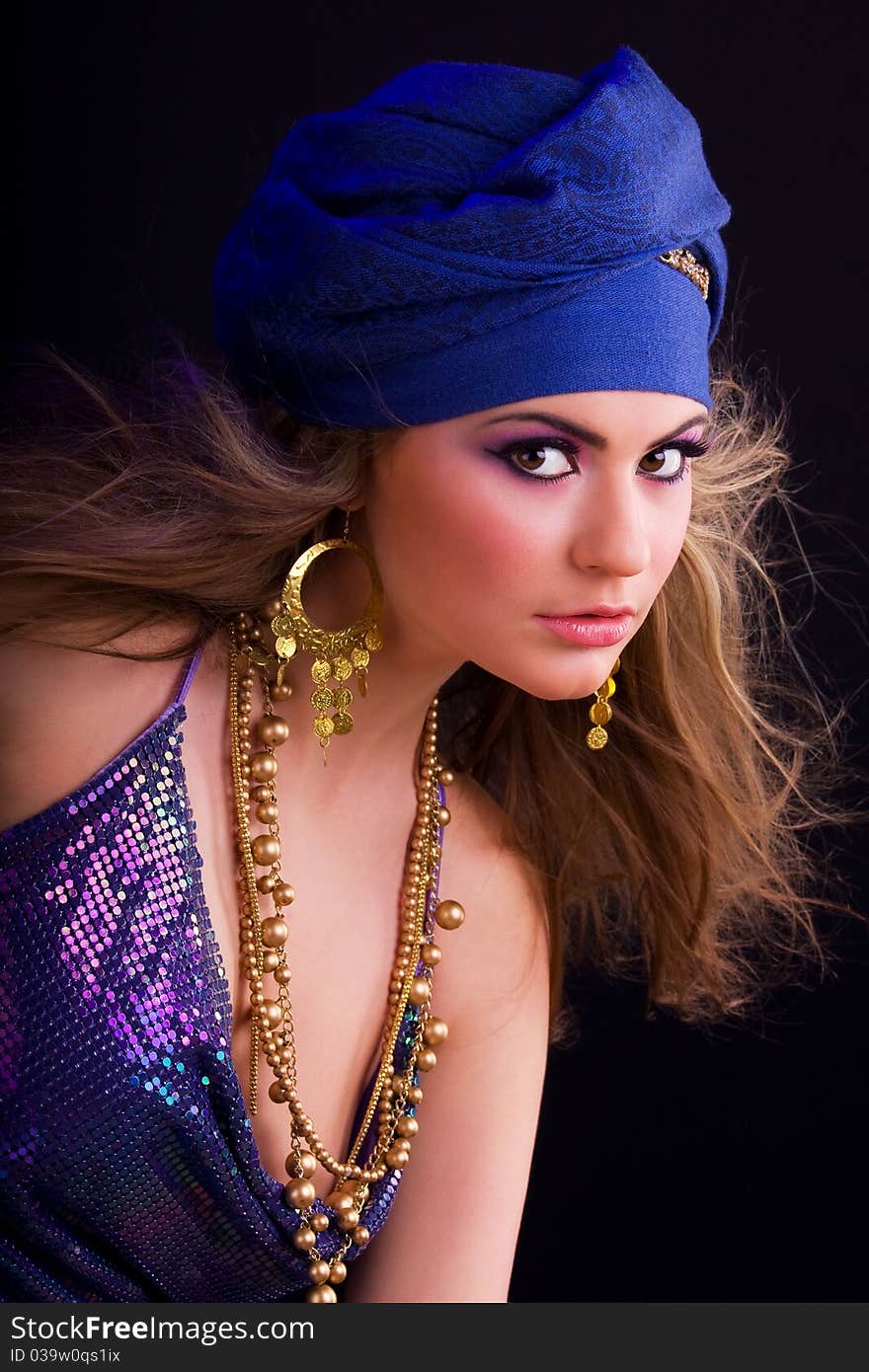 Beautiful girl in a turban and a stylized ethnic costume