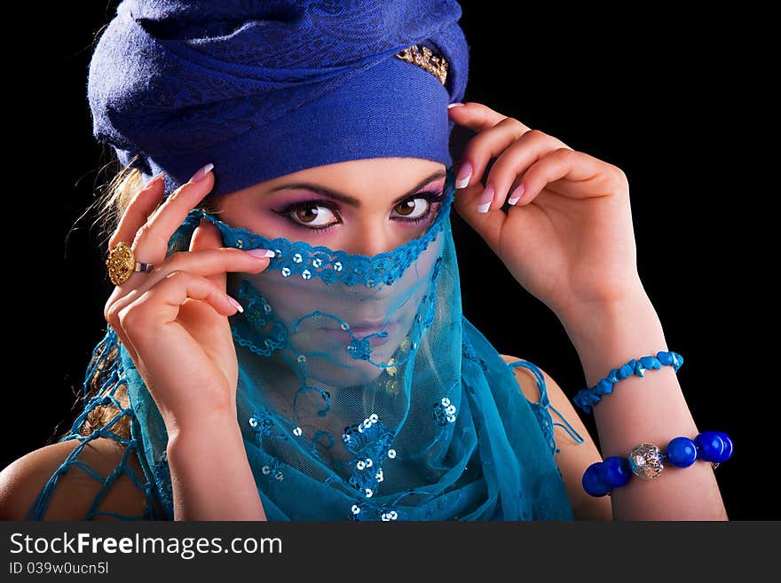 Beautiful girl in the stylized ethnic turban and veil