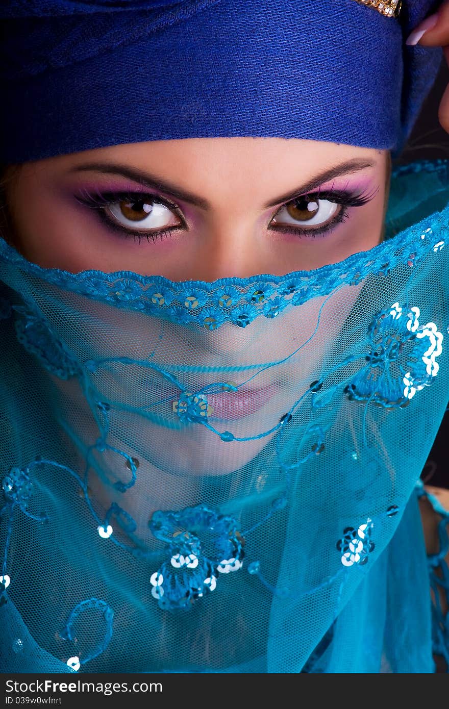 Beautiful girl in the stylized ethnic turban and veil