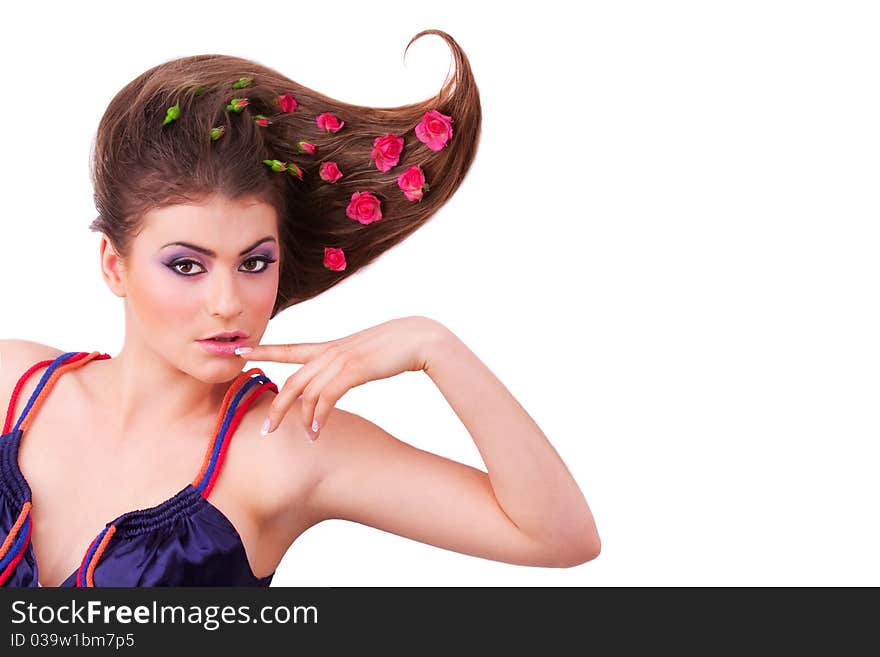 Pretty girl lying with flowers-roses in her hair