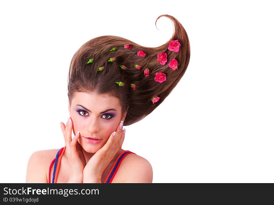 Pretty girl lying with flowers-roses in her hair