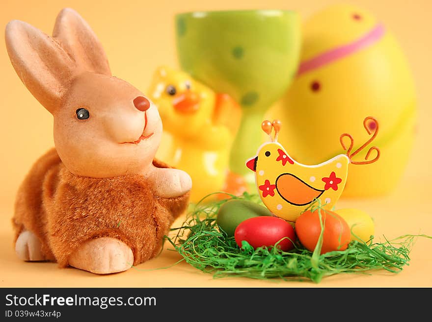 Easter bunny with colored eggs on yellow background. Easter bunny with colored eggs on yellow background